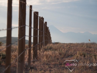 wooden fence posts and mountain backdrop